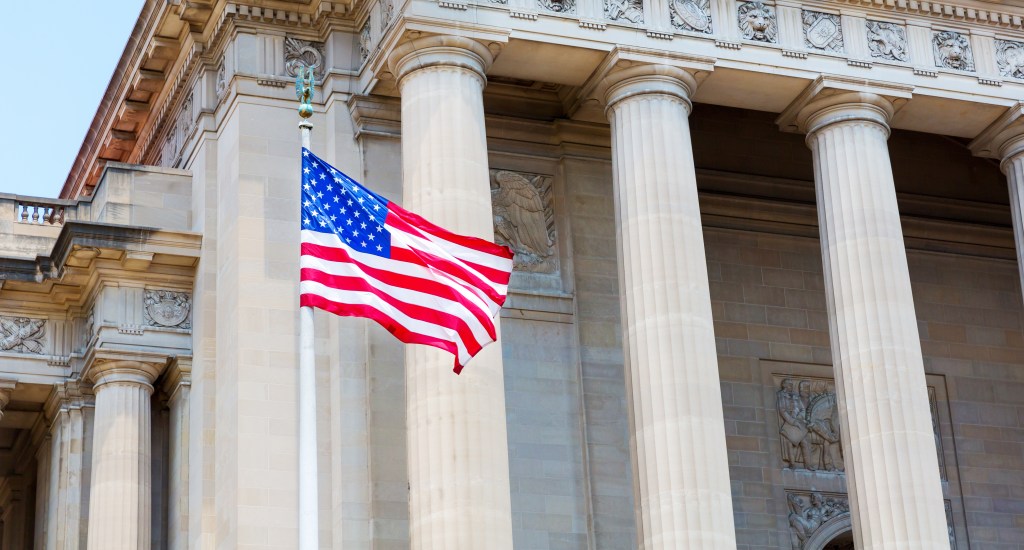 Washington DC Monuments with USA. Flag waving on window